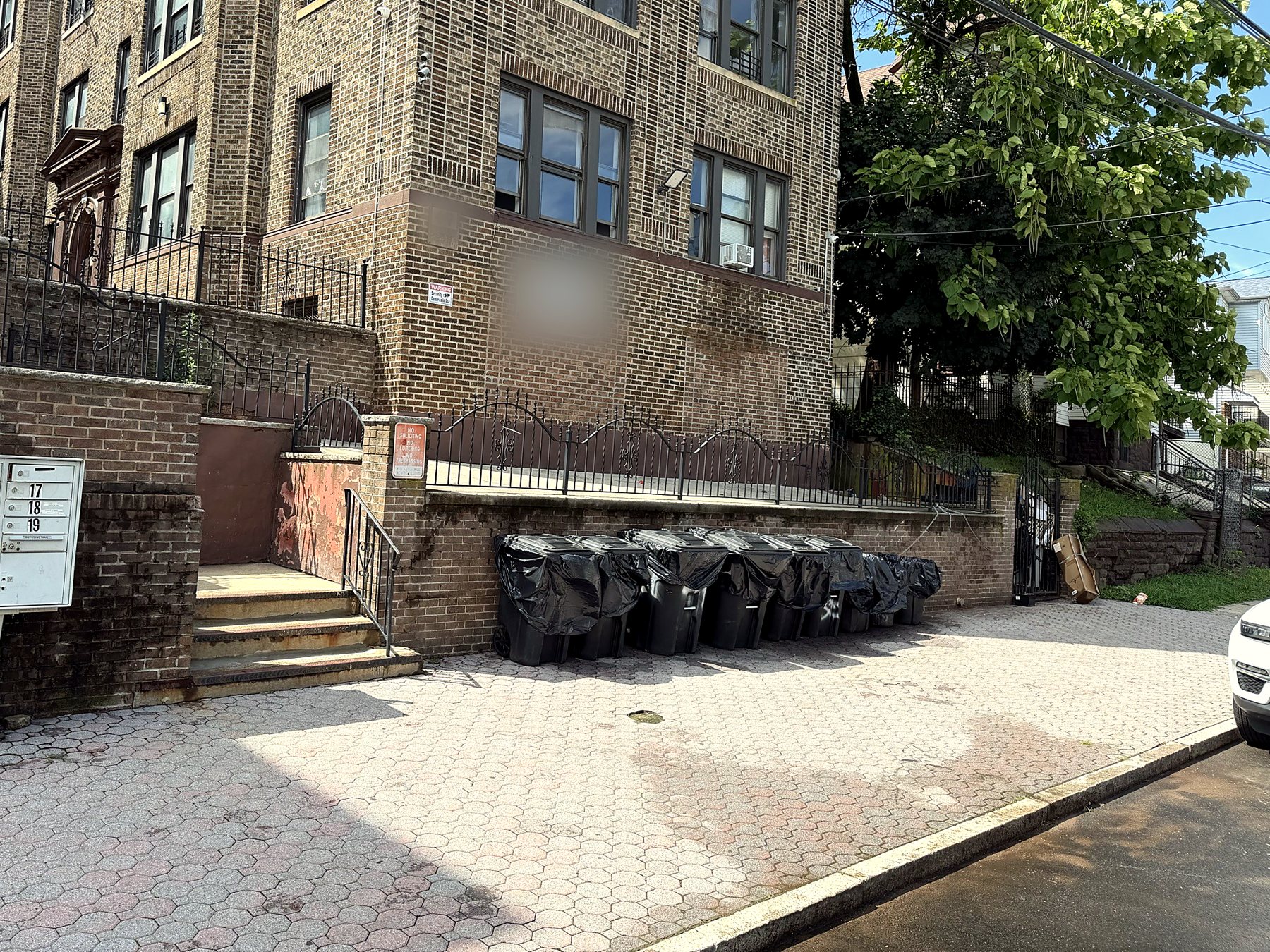 The building frontage with the trash area in order.