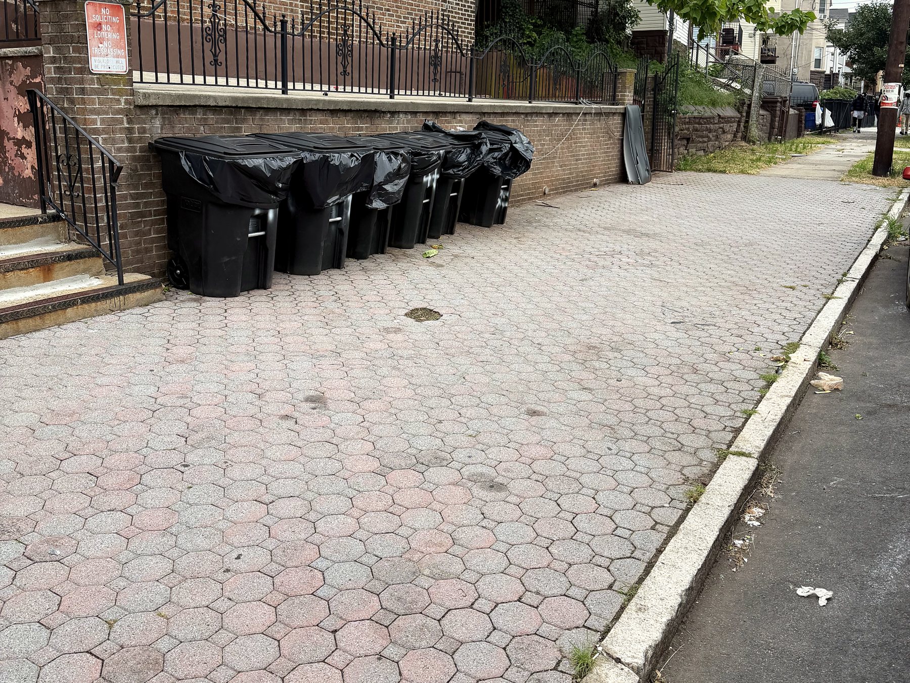 After: every bin lined up along the wall with a fresh liner, and the walkway swept clear.